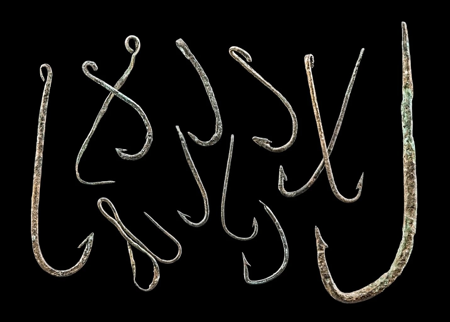 Antike Fischerhaken aus der Bronzezeit.Oder Buchstaben, die Wörter sammeln.